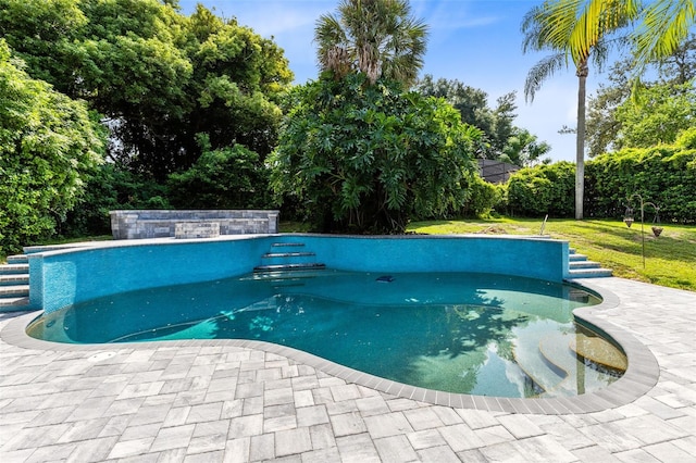 view of pool featuring a yard