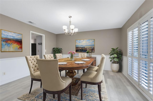 dining space featuring a chandelier and light hardwood / wood-style floors