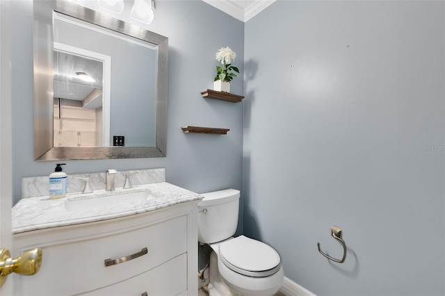 bathroom with crown molding, vanity, and toilet