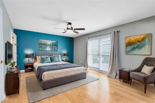 bedroom with ceiling fan and light wood-type flooring