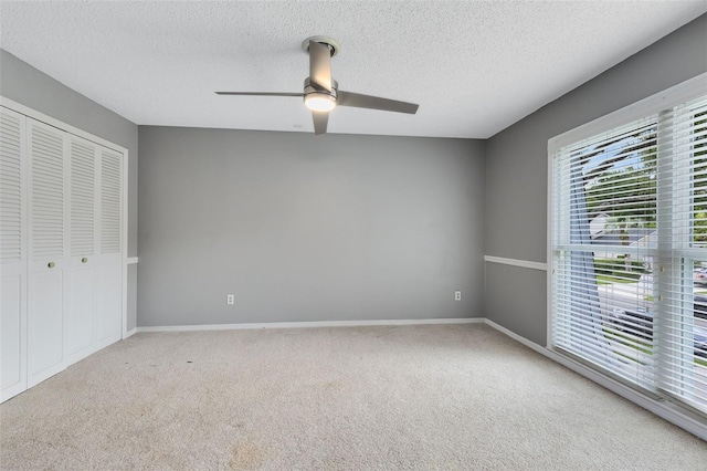 unfurnished bedroom with a closet, ceiling fan, and carpet