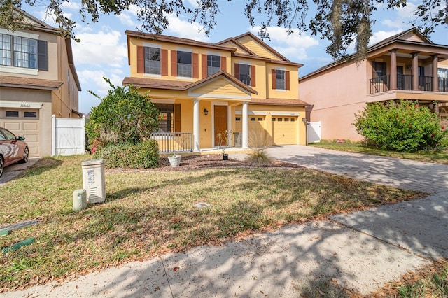 view of front of home featuring a garage, covered porch, and a front yard