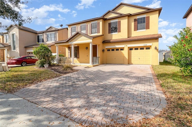 view of front of property with a garage and a front lawn