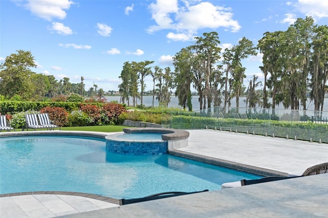 view of swimming pool with an in ground hot tub