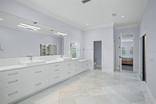 bathroom featuring toilet, ornamental molding, vanity, and tile patterned floors