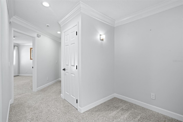 carpeted empty room with ornamental molding and a textured ceiling