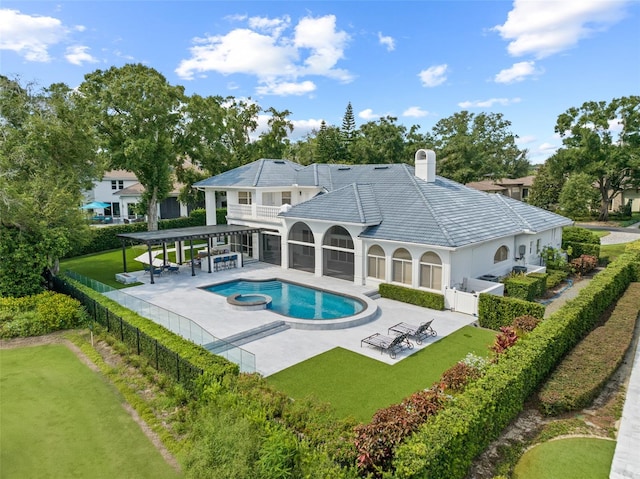 view of pool featuring a patio, a yard, and an in ground hot tub