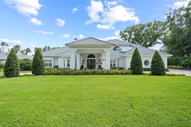 mediterranean / spanish-style home with a front yard