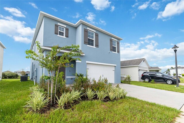 view of front of home featuring a garage and a front lawn