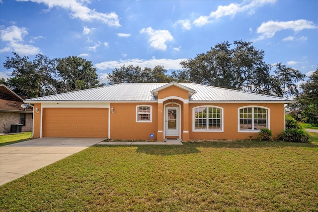 ranch-style home featuring a front yard, a garage, and cooling unit