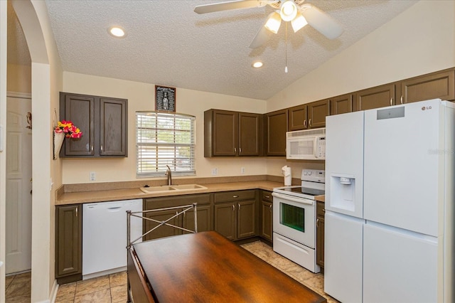 kitchen featuring sink, ceiling fan, light tile patterned floors, white appliances, and vaulted ceiling