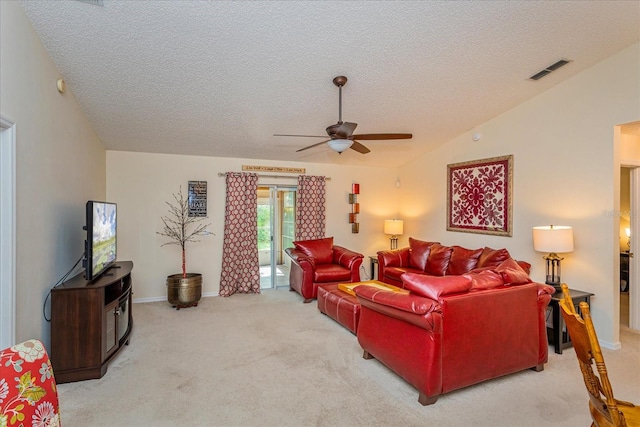 living room featuring a textured ceiling, carpet floors, lofted ceiling, and ceiling fan