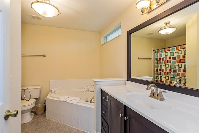 bathroom featuring tiled tub, tile patterned flooring, vanity, and toilet