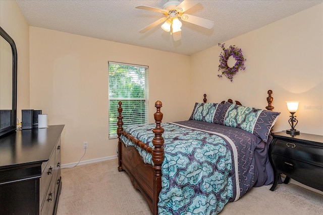 carpeted bedroom with a textured ceiling and ceiling fan