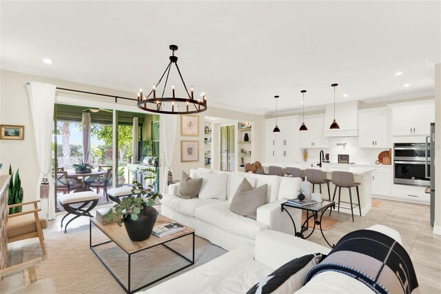 living room featuring ornamental molding, recessed lighting, an inviting chandelier, and light tile patterned floors