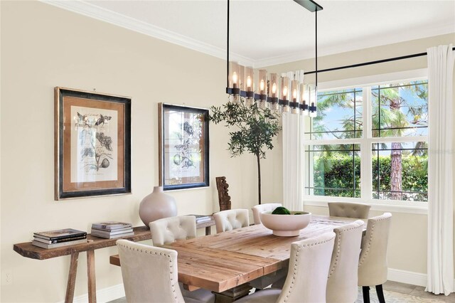 dining space featuring ornamental molding, a wealth of natural light, a notable chandelier, and baseboards