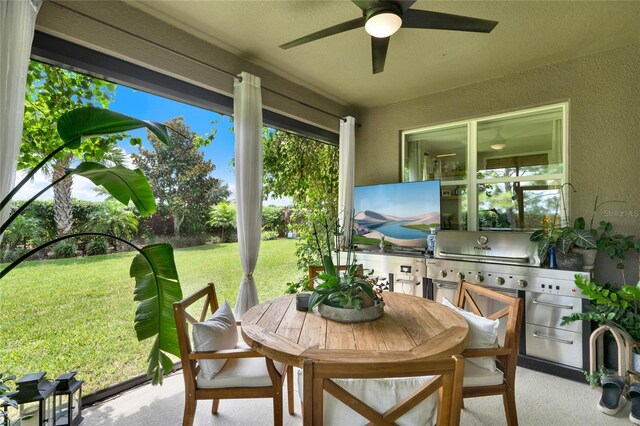 sunroom featuring ceiling fan