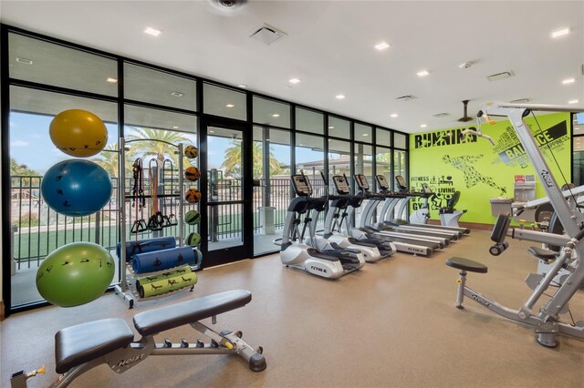 exercise room featuring a wall of windows and visible vents