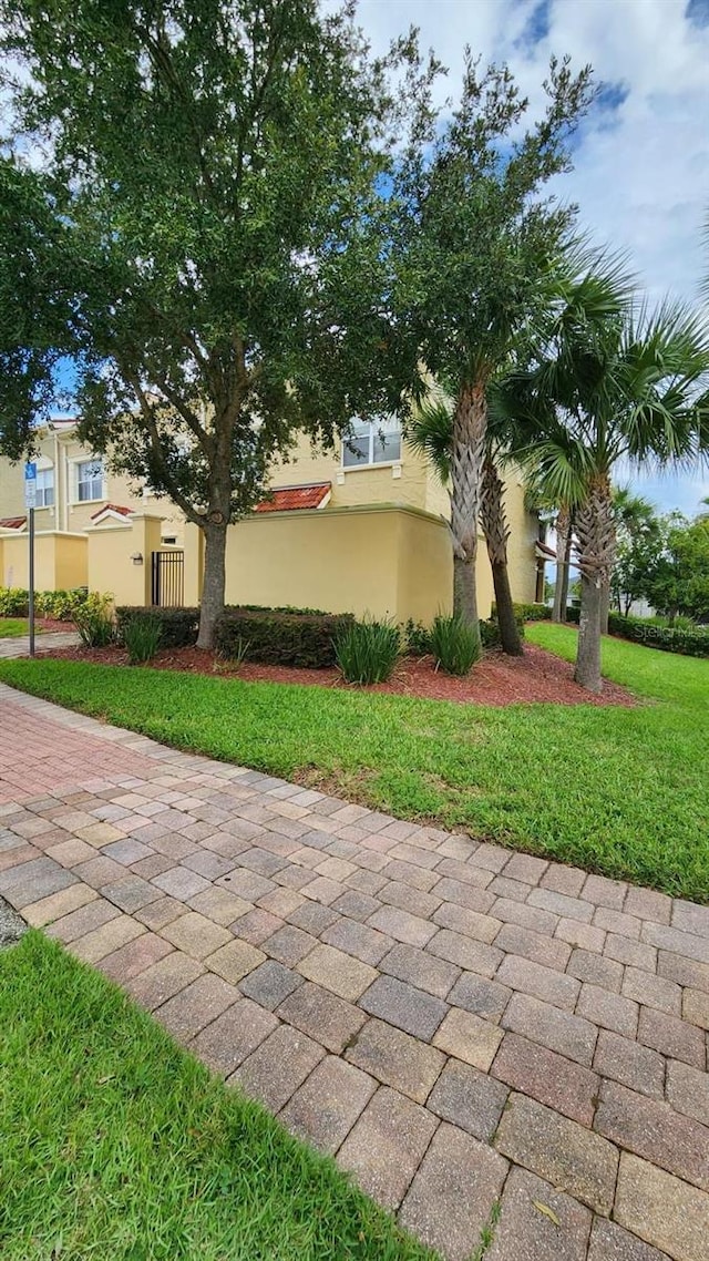 view of side of property with a lawn