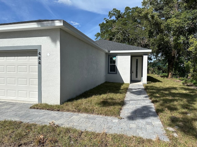 view of front of home featuring a garage and a front lawn