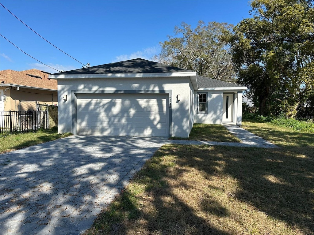 view of front of house with a garage and a front lawn