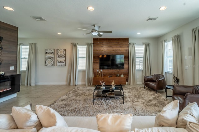 tiled living room with ceiling fan