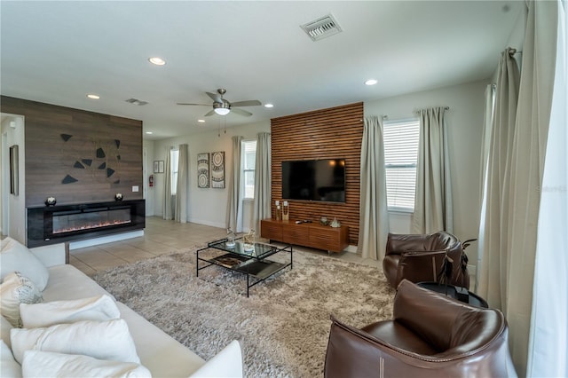 tiled living room with ceiling fan