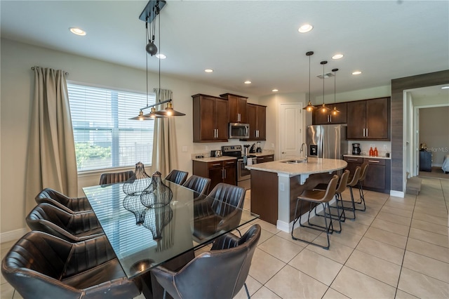 dining space with light tile patterned flooring and sink