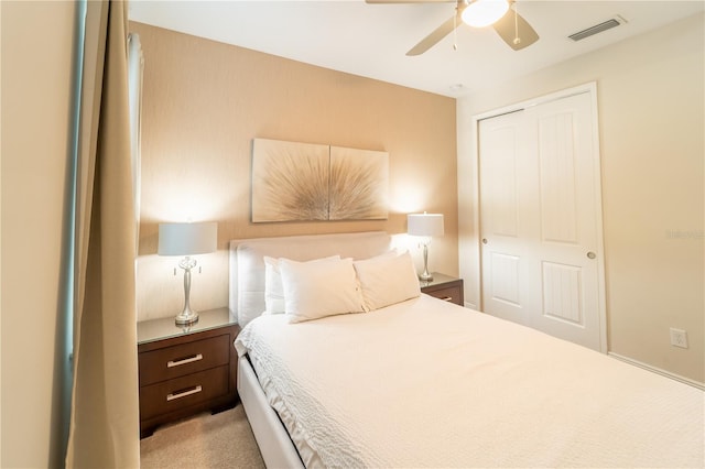 bedroom featuring a closet, ceiling fan, and light colored carpet