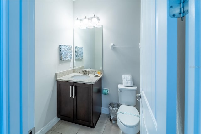 bathroom featuring tile patterned floors, toilet, and vanity