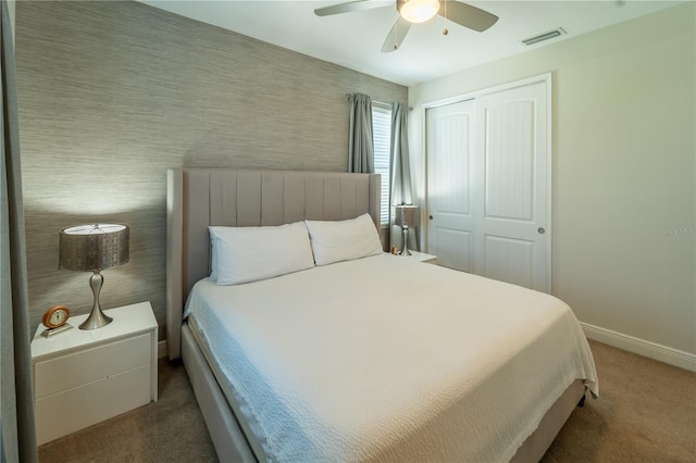 bedroom featuring ceiling fan, carpet, and a closet