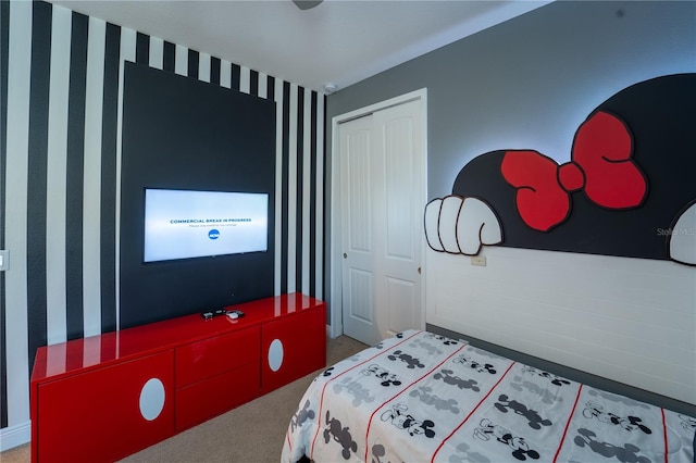 bedroom with carpet and a closet