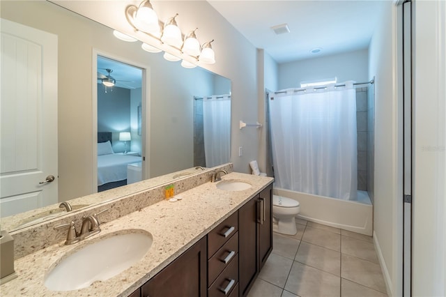 full bathroom featuring tile patterned floors, shower / tub combo, vanity, ceiling fan, and toilet