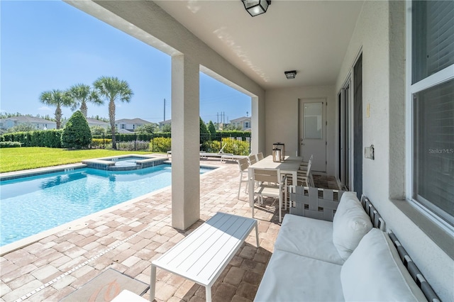 view of swimming pool with an in ground hot tub and a patio