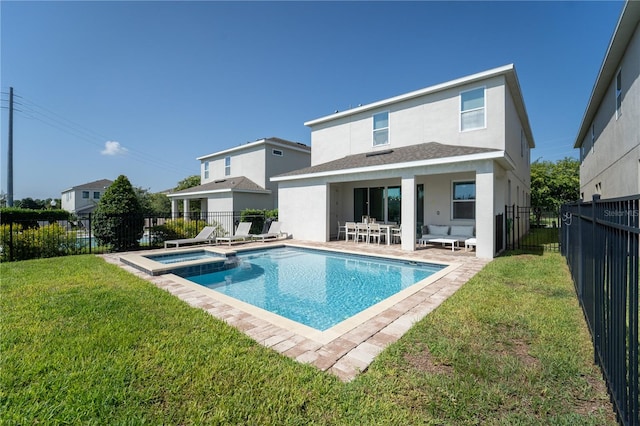 rear view of house featuring a patio, a yard, and a fenced in pool