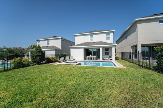 rear view of house with a patio area, a fenced in pool, and a lawn