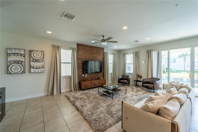 living room with ceiling fan and light tile patterned flooring