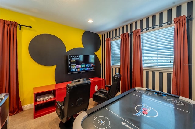 recreation room with light colored carpet