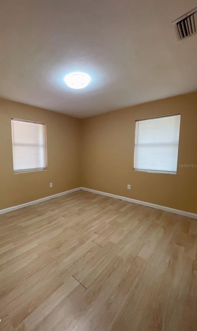 unfurnished room featuring light hardwood / wood-style flooring