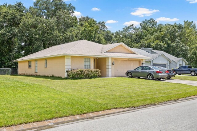 single story home with a garage and a front yard