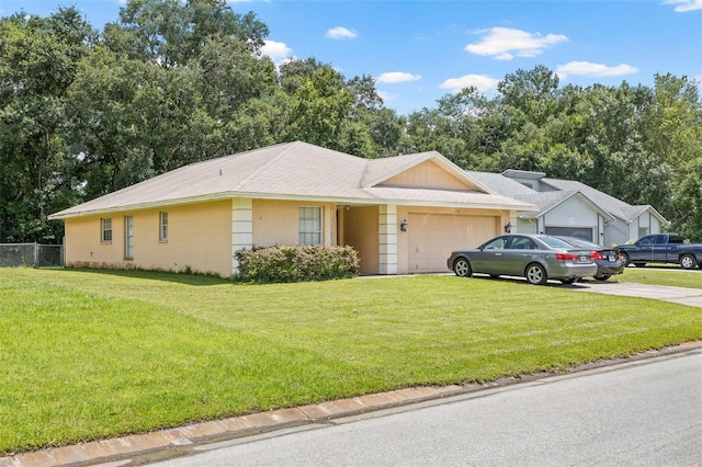 single story home with a garage, fence, concrete driveway, and a front yard