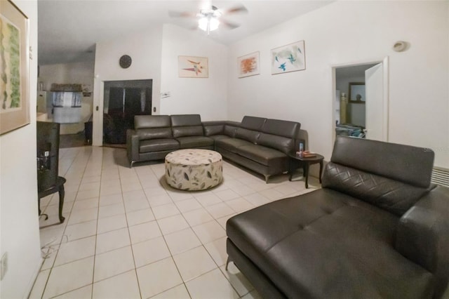 living room with vaulted ceiling, light tile patterned floors, and ceiling fan