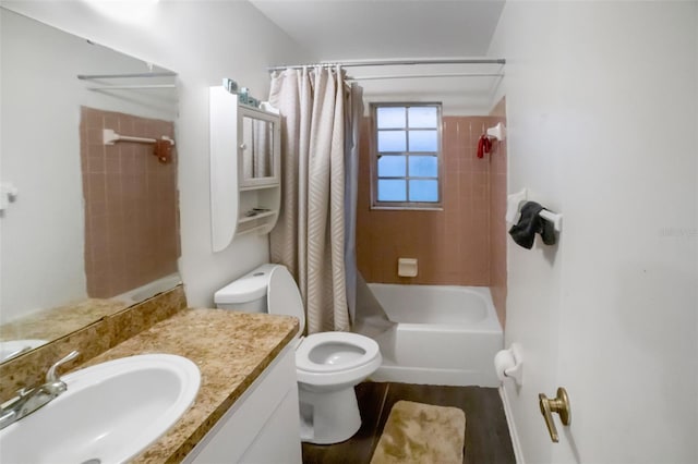 full bathroom with shower / bath combo with shower curtain, hardwood / wood-style floors, toilet, and vanity