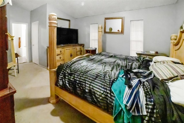 bedroom featuring lofted ceiling and carpet flooring