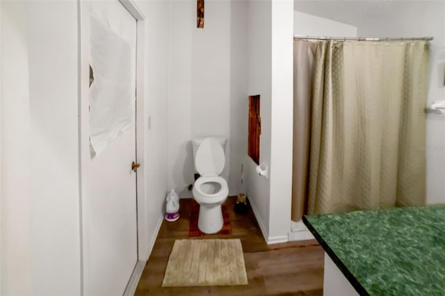 bathroom with a shower with shower curtain, vanity, toilet, and wood-type flooring