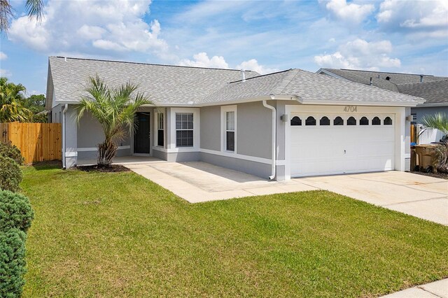 view of front facade with a garage and a front yard