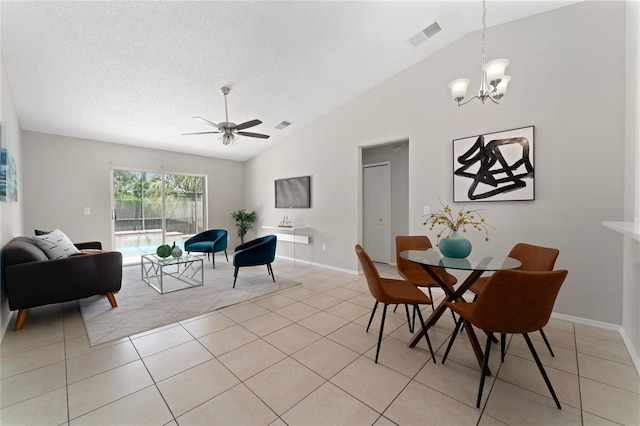 dining space with lofted ceiling, light tile patterned floors, visible vents, and a textured ceiling