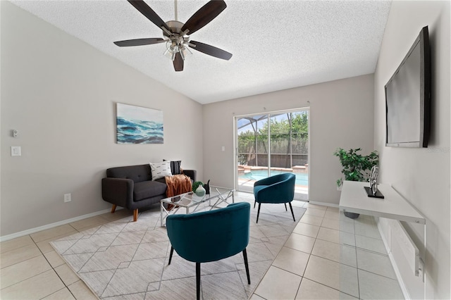 living room with a textured ceiling, light tile patterned flooring, lofted ceiling, and baseboards