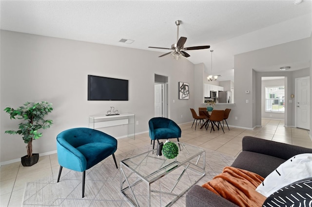 living area with light tile patterned floors, lofted ceiling, visible vents, ceiling fan, and a textured ceiling