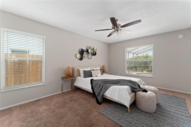 bedroom with a ceiling fan, carpet, a textured ceiling, and baseboards